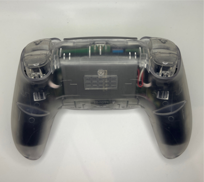 PS5 controller with transparent casing showing off transparent triggers on a white background