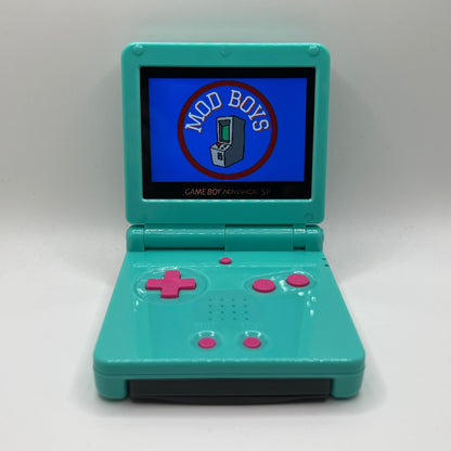 Teal Game Boy Advance SP with pink buttons. The screen is displaying 'Mod Boys' logo on a white background